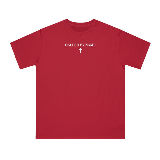 Red t-shirt with white text 'CALLED BY NAME' and a white cross below on the chest