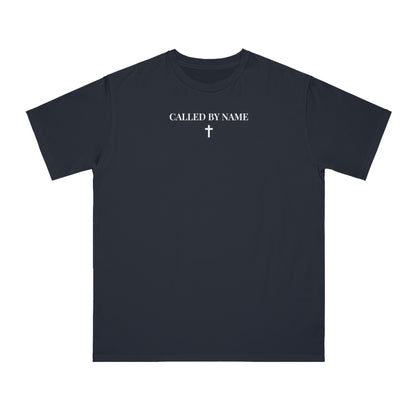 Black t-shirt with white text 'CALLED BY NAME' and a small white cross graphic centered on chest