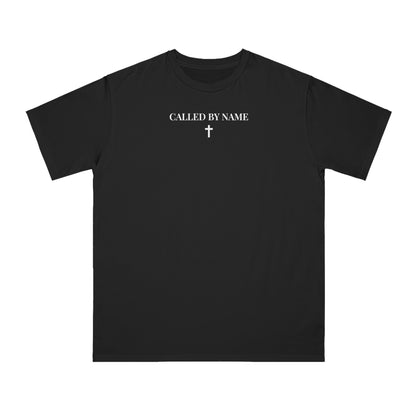 Black T-shirt with white text 'CALLED BY NAME' and a small cross graphic below